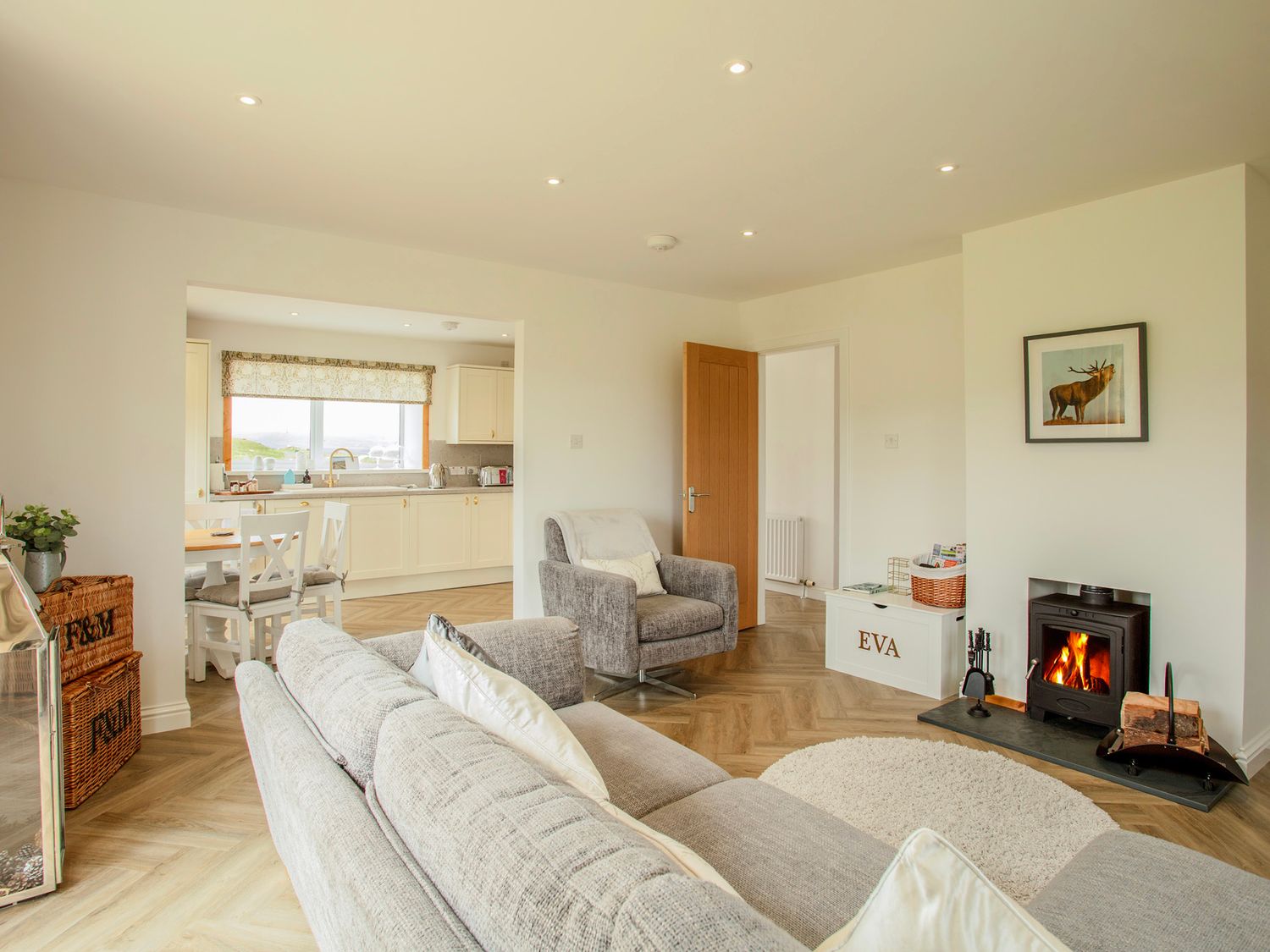 Sitting room and kitchen at Taigh Eva with woodburning stove
