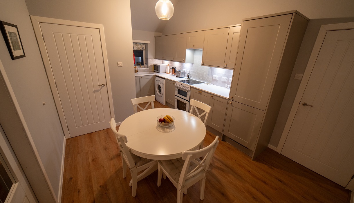 Am Bliochan self catering cottage north uist - Kitchen with double doors to living room, door to porch and door to hall.