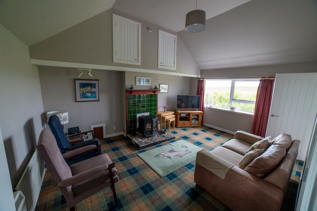 Am Bliochan self catering cottage north uist - living room with mutli-fuel stove