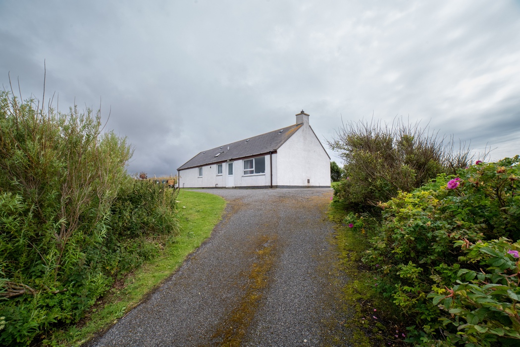 Am Bliochan self catering cottage north uist - exterior view from driveway.